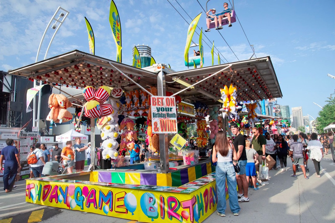 A busy outdoor fair with game booths